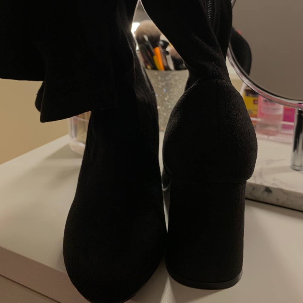 knee high heeled boots.